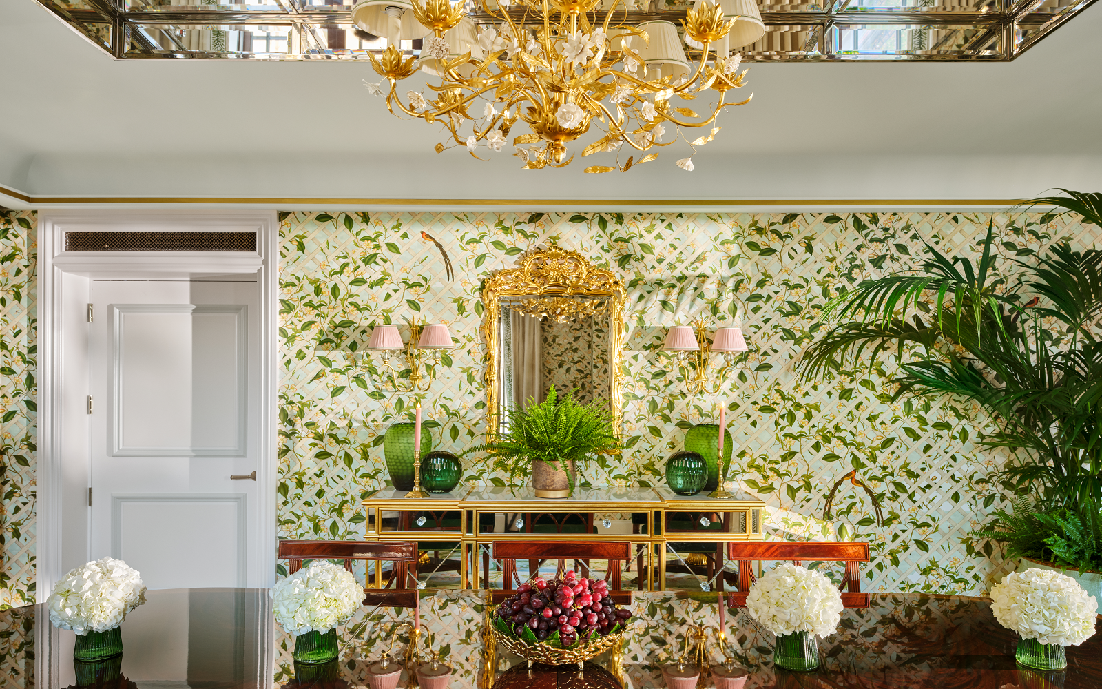 dining room with gold chandelier and garden trellis wallpaper in The dorchester Royal suite