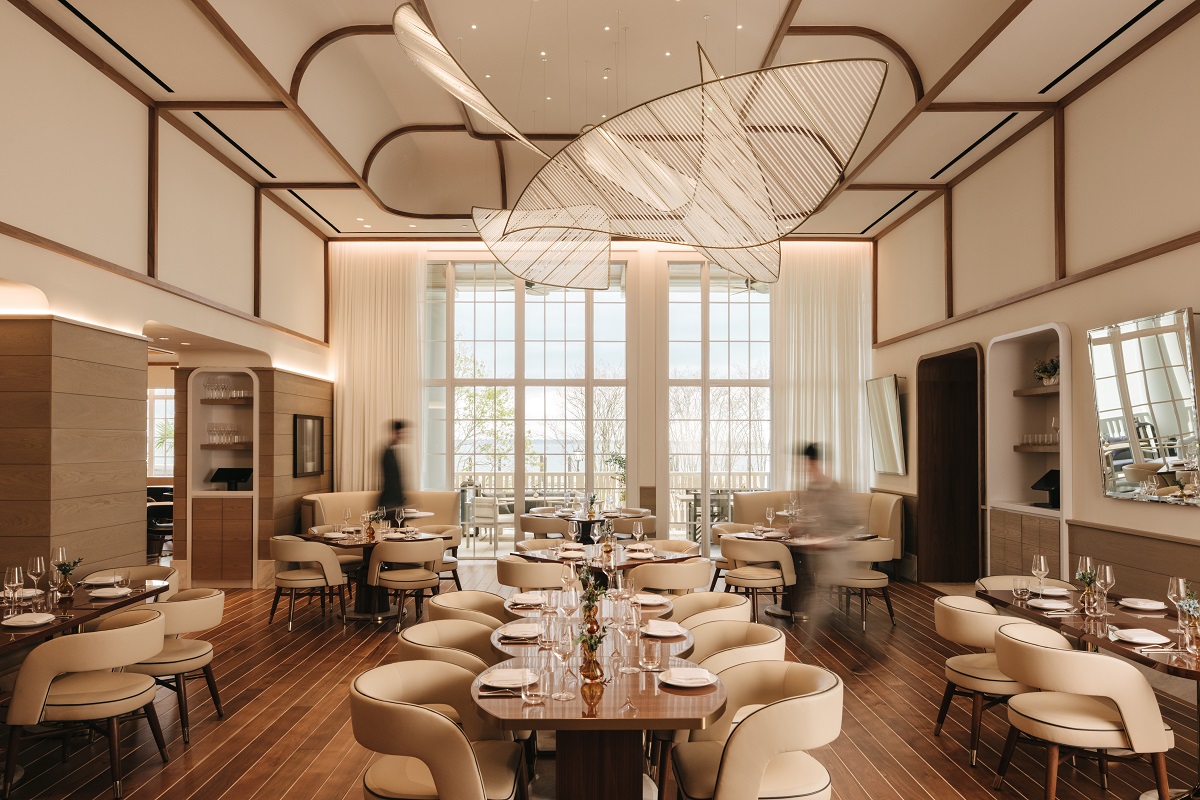 The Crossing restaurant with vaulted ceiling in wood and cream design by Meyer Davis