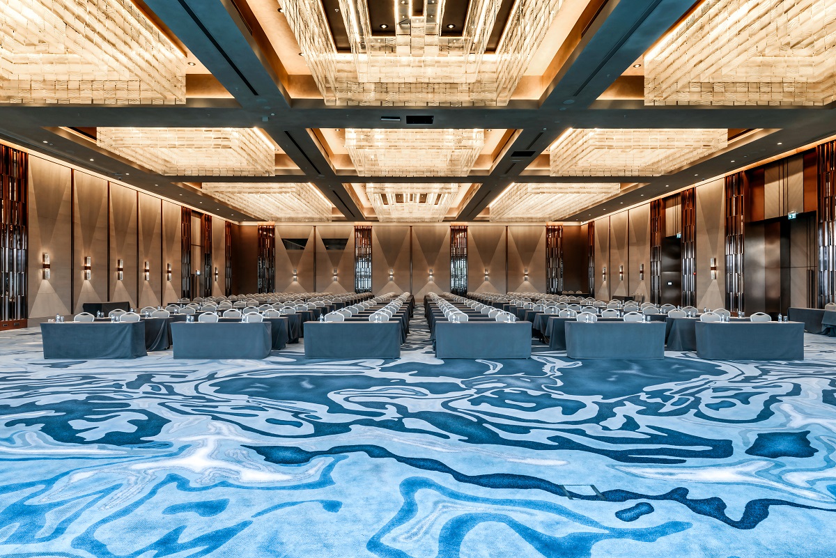 bold swirl patterned blue carpet in hotel ballroom