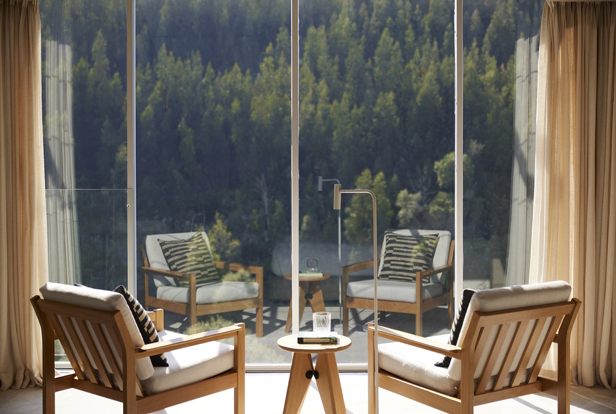 wooden chairs in front of window looking onto douro river