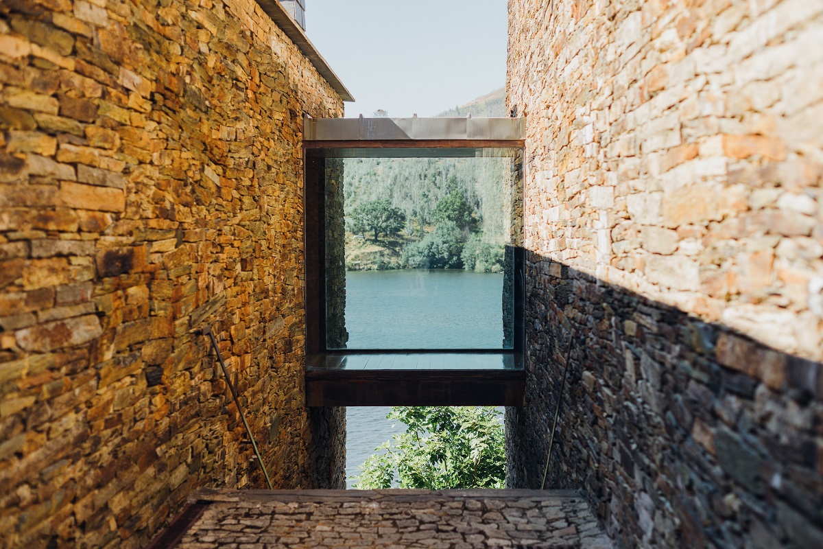 glass framed view of river with framed with stone walls