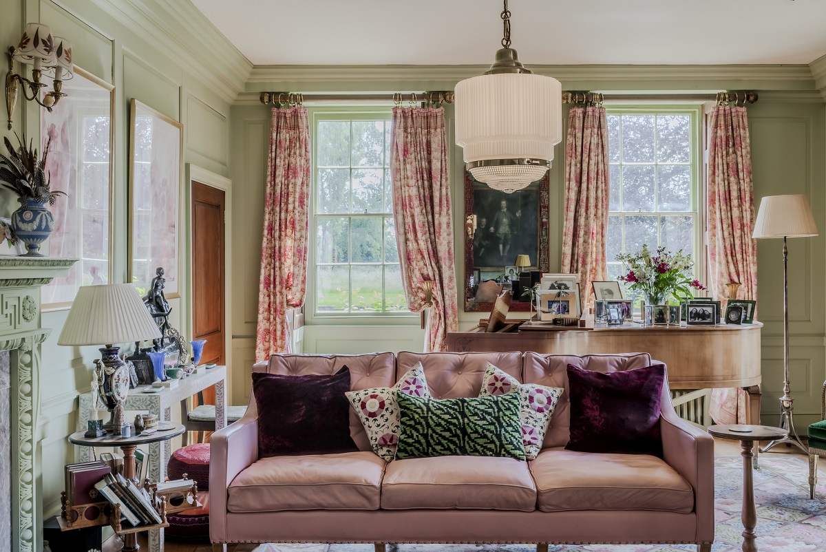 room with pink couch and vintage style glass pendant light