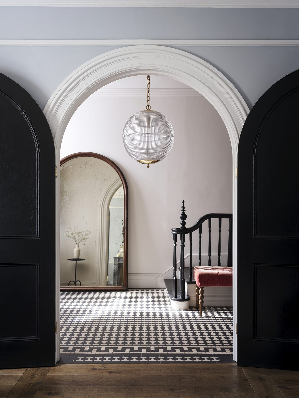 glass pendant seen through double arched doors