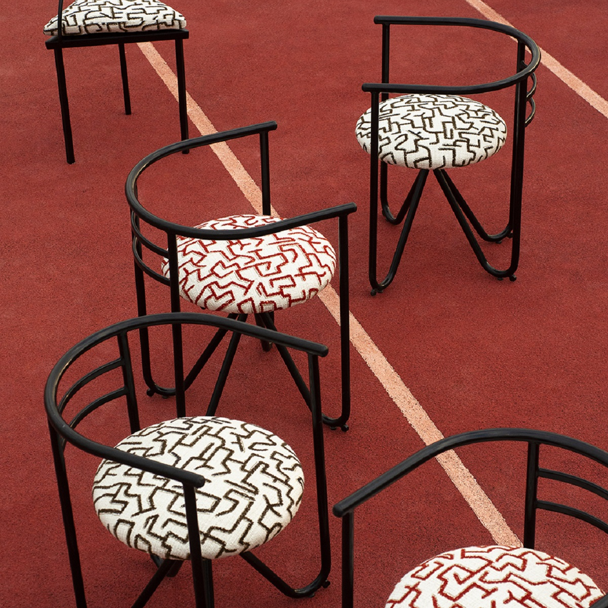 graphic chair design with Dedar fabric placed on tennis court