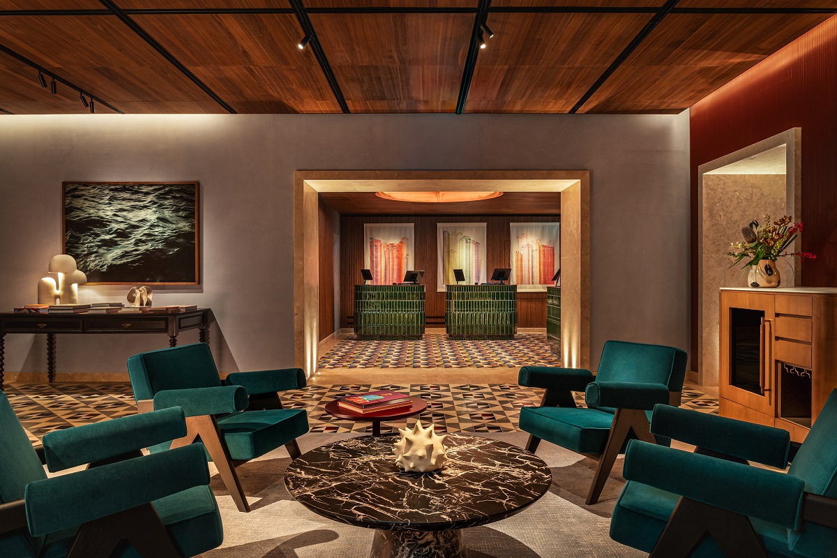 blue chairs around marble table in front of hotel reception in Andaz Lisbon