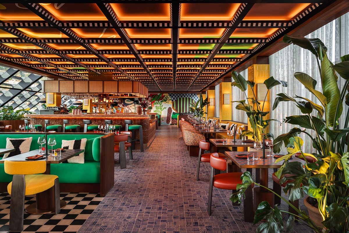 bright primary colour seating, wooden ceiling and checked floor in Luzzi restaurant