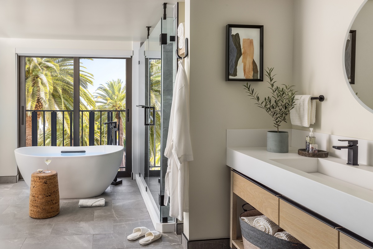 freestanding bath in front of floor to ceiling window