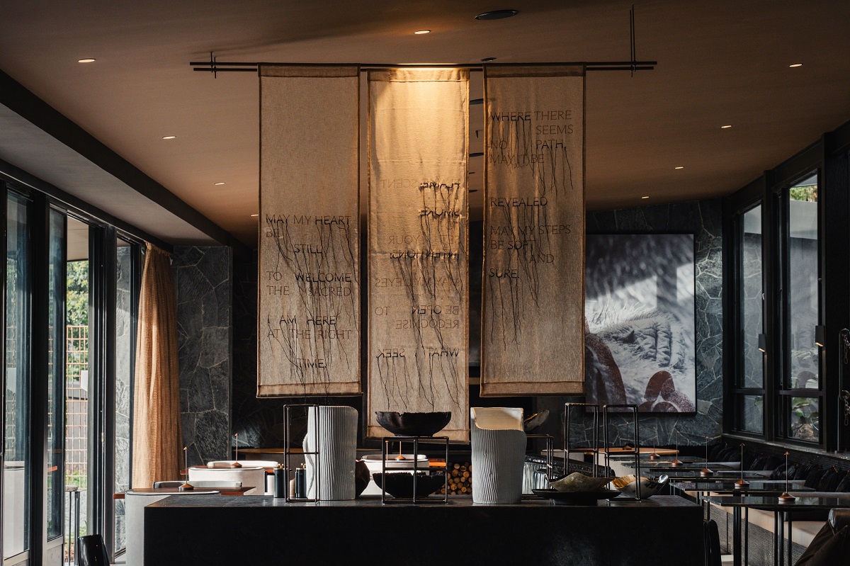 dining room in black and brown with focal wall hanging from Milaya Project