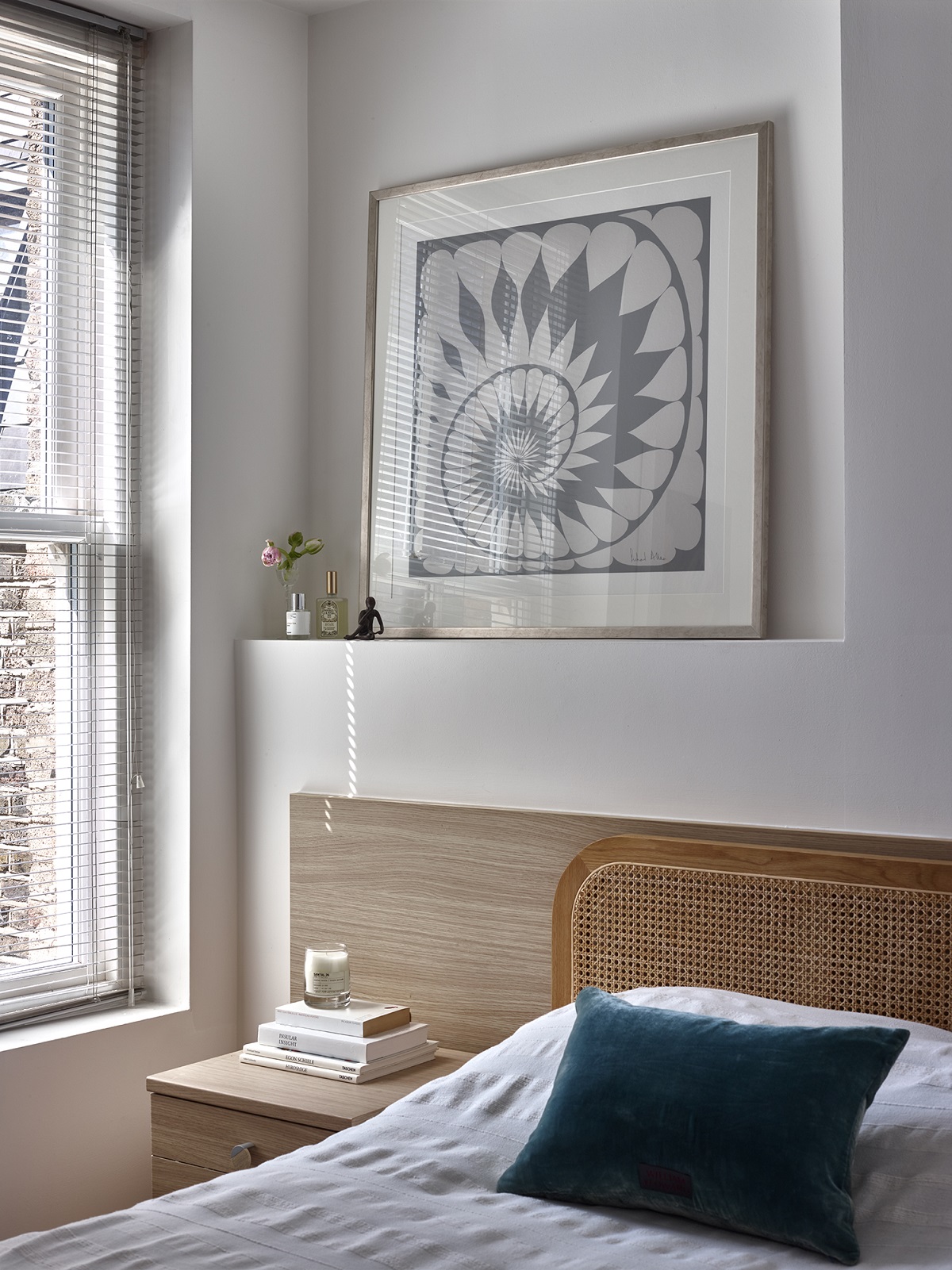 bedroom detail with bed next to window and framed art above the bed - Maren soft grey
