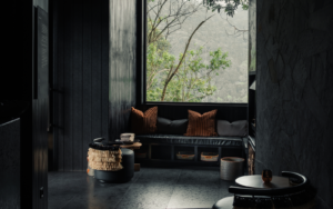 black walls and floors with view over rainforest at Silverback Lodge, Uganda