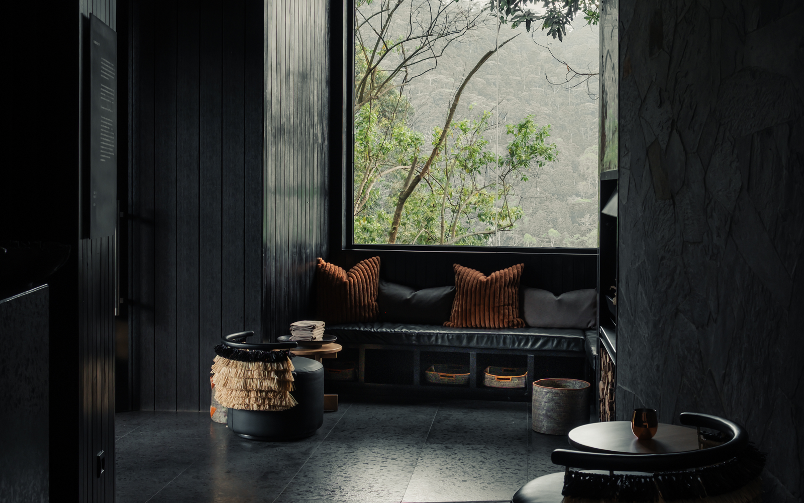 black walls and floors with view over rainforest at Silverback Lodge, Uganda