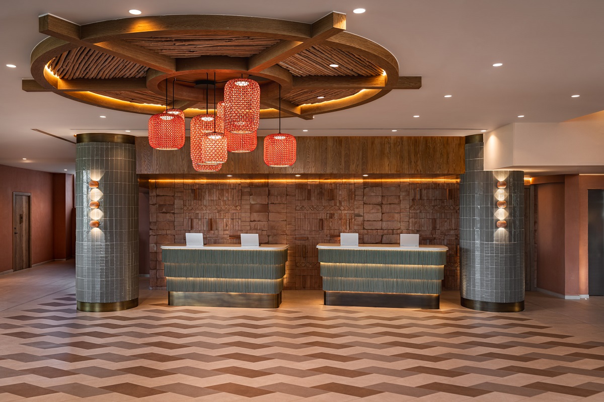 Hyatt Regency Vilamoura lobby with patterned floor, tiled desks and woven lighting