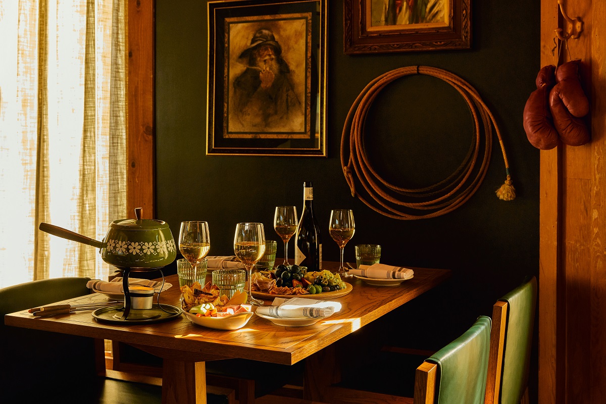 set table with vintage painting and wood panelling in . Trailborn Jackson Hole_Old Timer_ restaurant