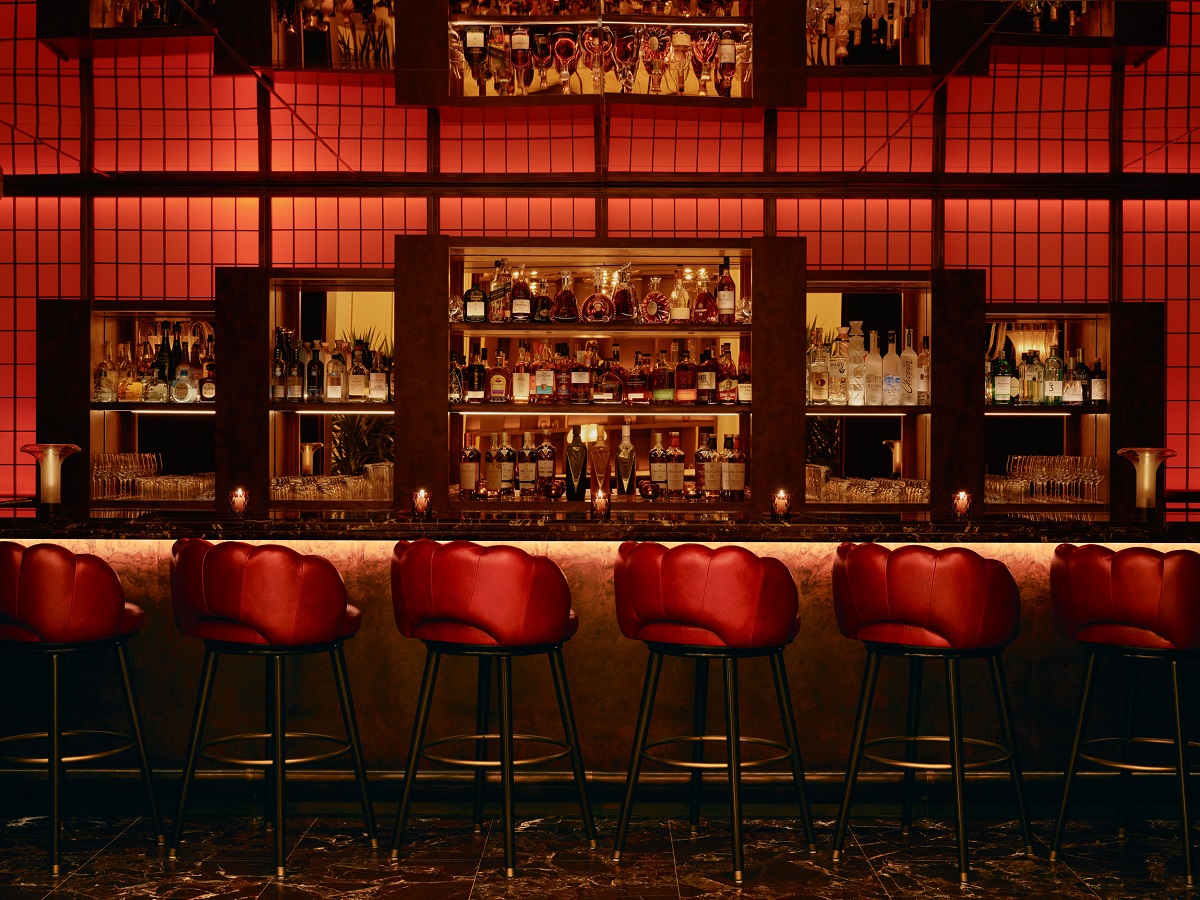bar stools in front of red reflective Rose Bar