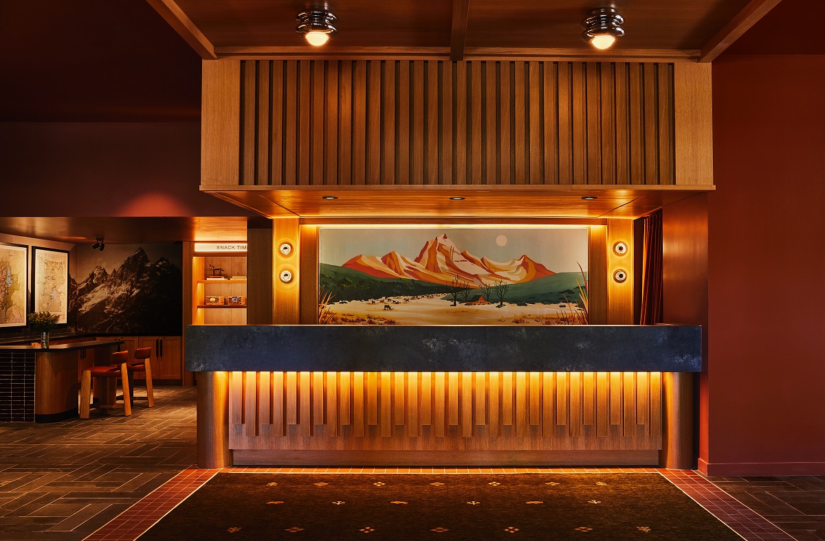 wooden front desk and panelling with western painting in Trailborn Jackson Hole_Front Desk