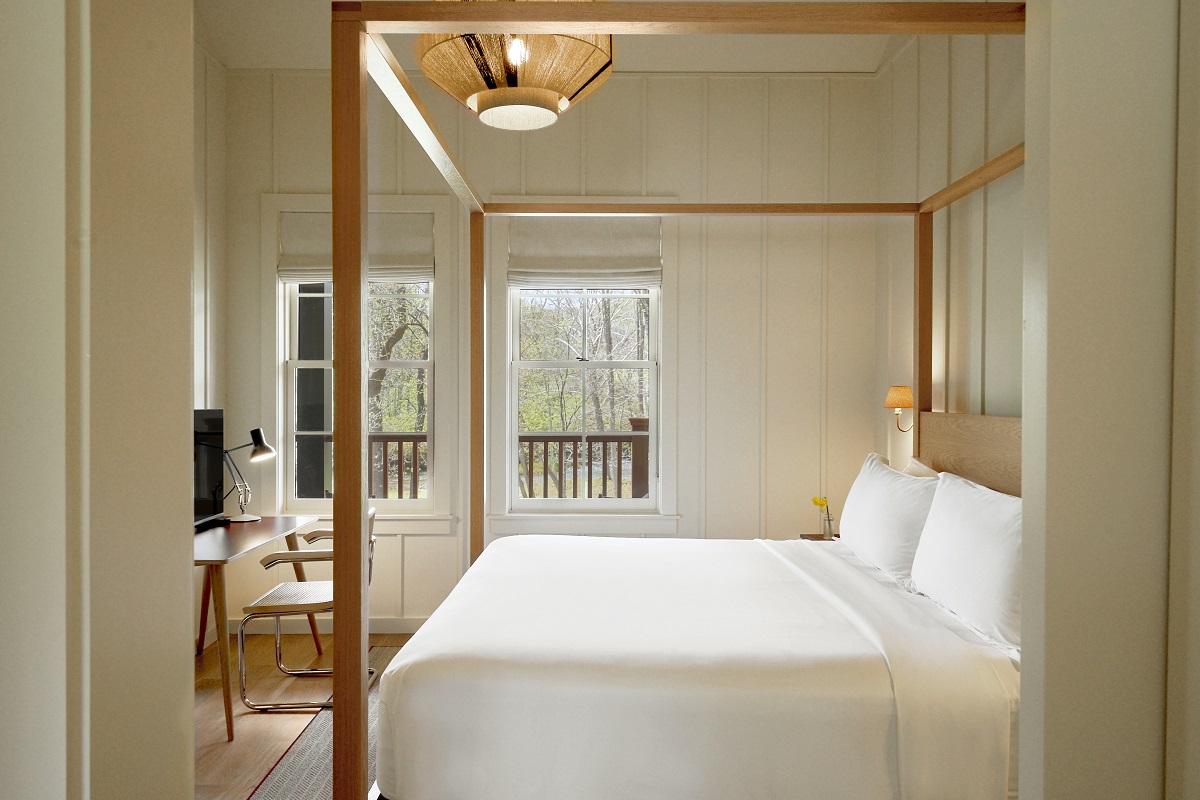 bedroom in Troutbeck_Cottages_with four poster bed, white linen and views outdoors