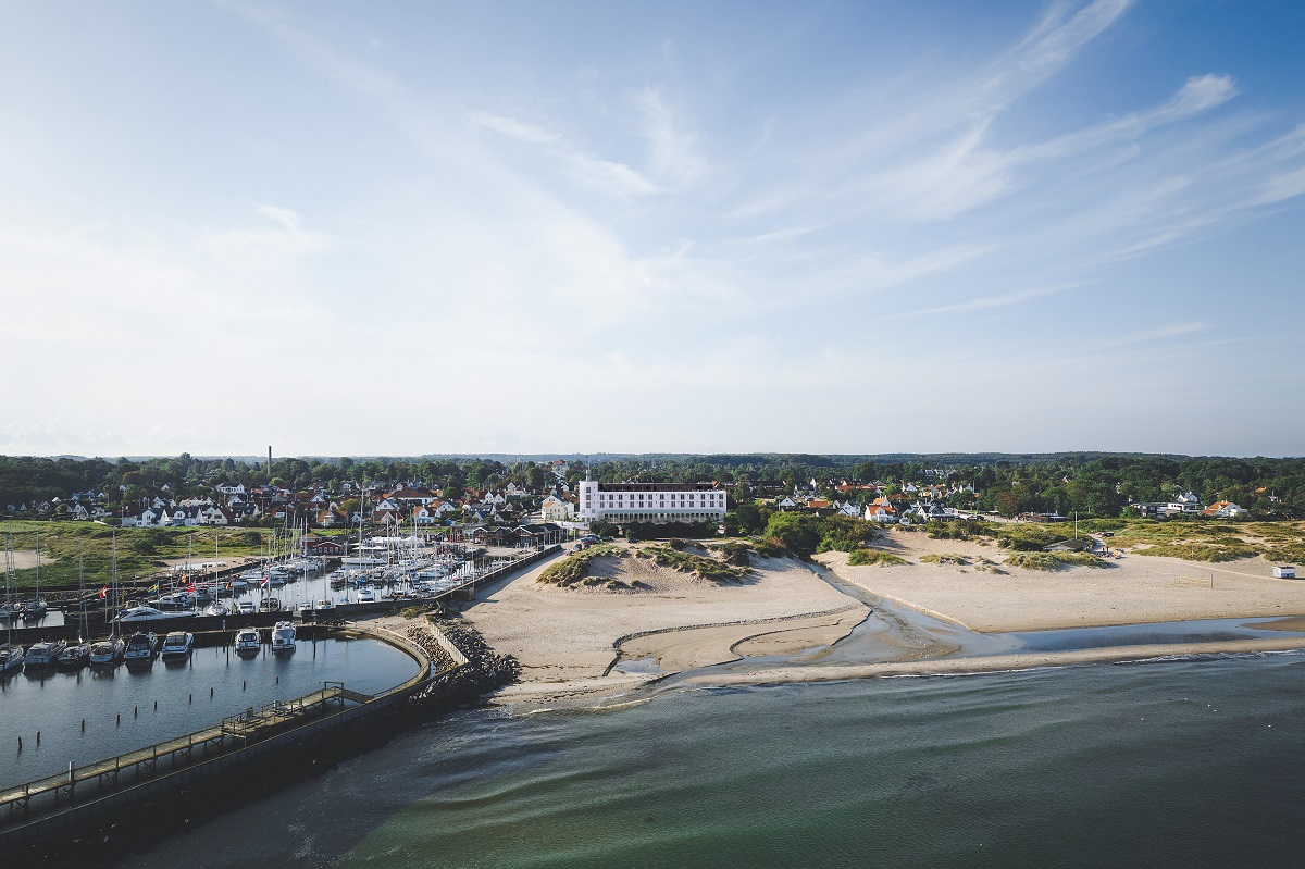 aerial view of landscape and beach with hotel rendering - CORI Hornbæk Hotel