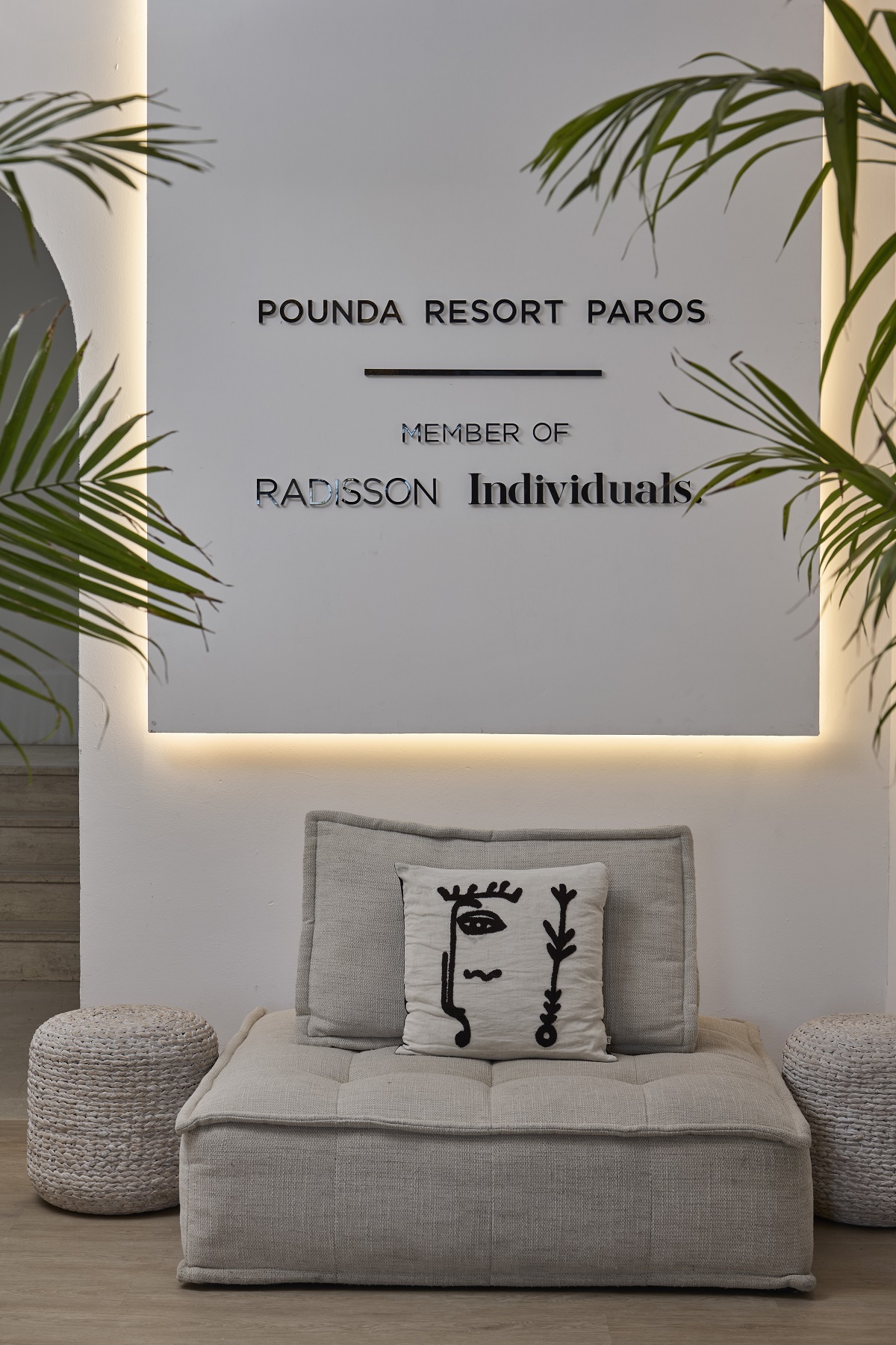 relaxed chair below resort signage Pounda Resort Paros,