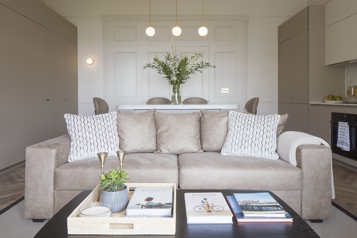 couch with coffee table in cream and natural interior in Regency Square Suites _ Suite 3