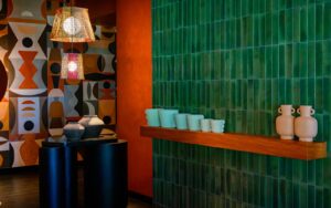 green tiled wall - orange pillar - painted mural in Salted Egg Darwin