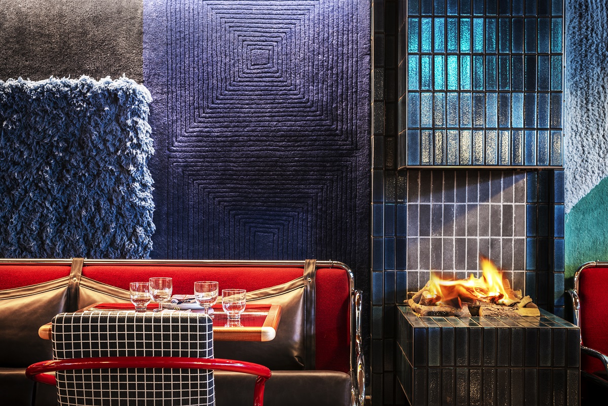 blue tiled fireplace and red seating