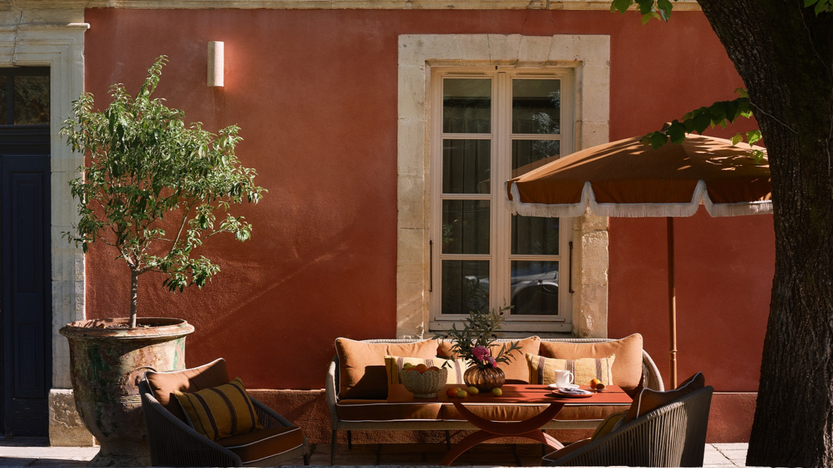 pink plaster, umbrella and couch outside villa augusta