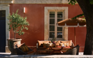 pink plaster, umbrella and couch outside villa augusta