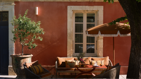 pink plaster, umbrella and couch outside villa augusta