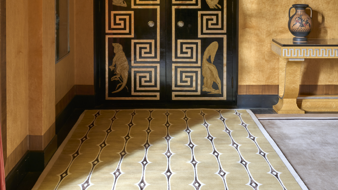 Pelican carpet rug on the floor with ochre walls and decorative door