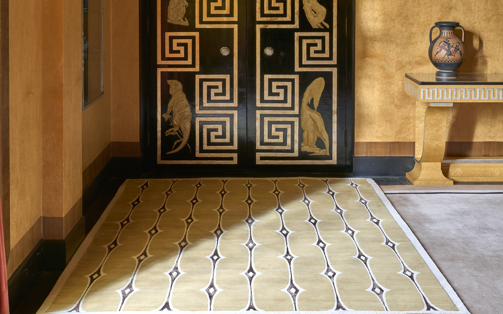 Pelican carpet rug on the floor with ochre walls and decorative door