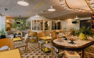 restaurant and lobby space under curved lighting feature in Wilde Porto