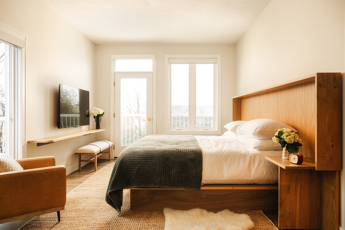 guestroom in Dexter Hotel with wooden headboard and white linen