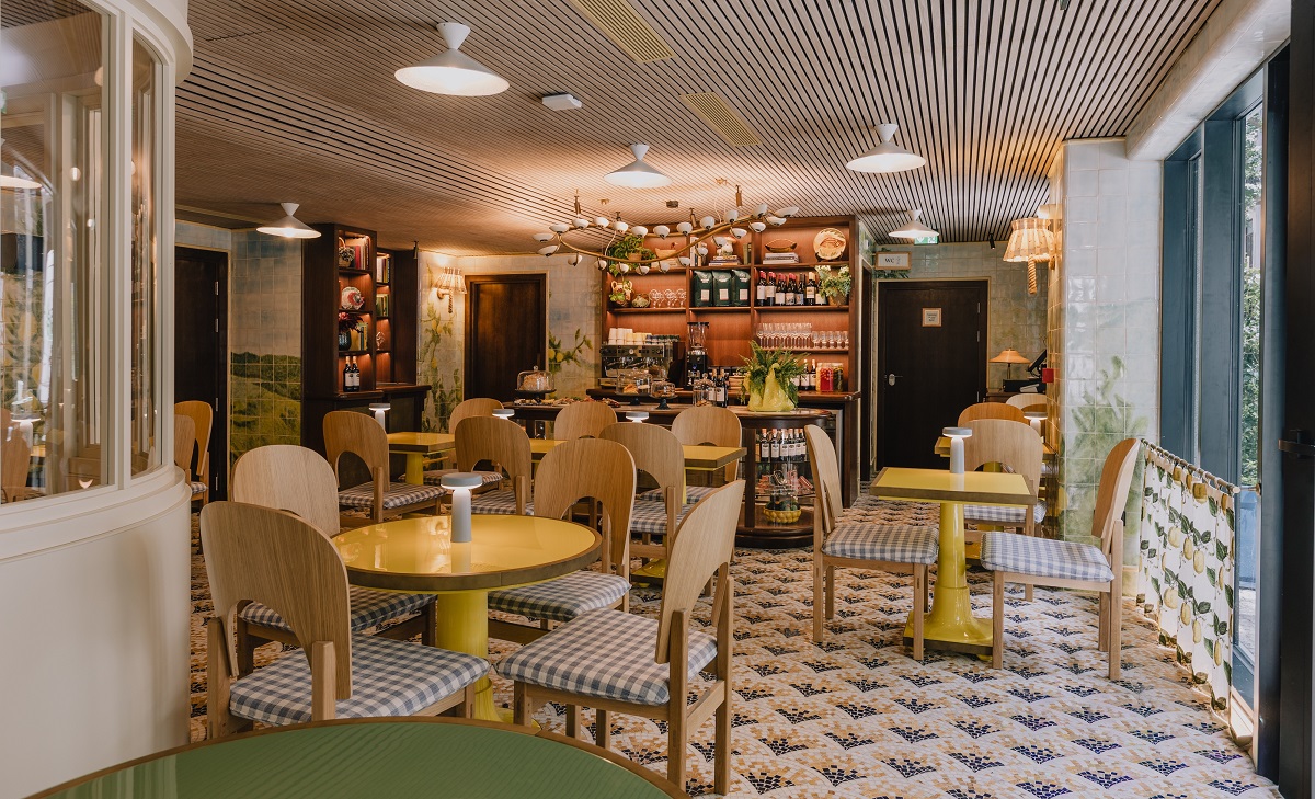 tiled floor, round wooden tables and seating in Wilde Porto