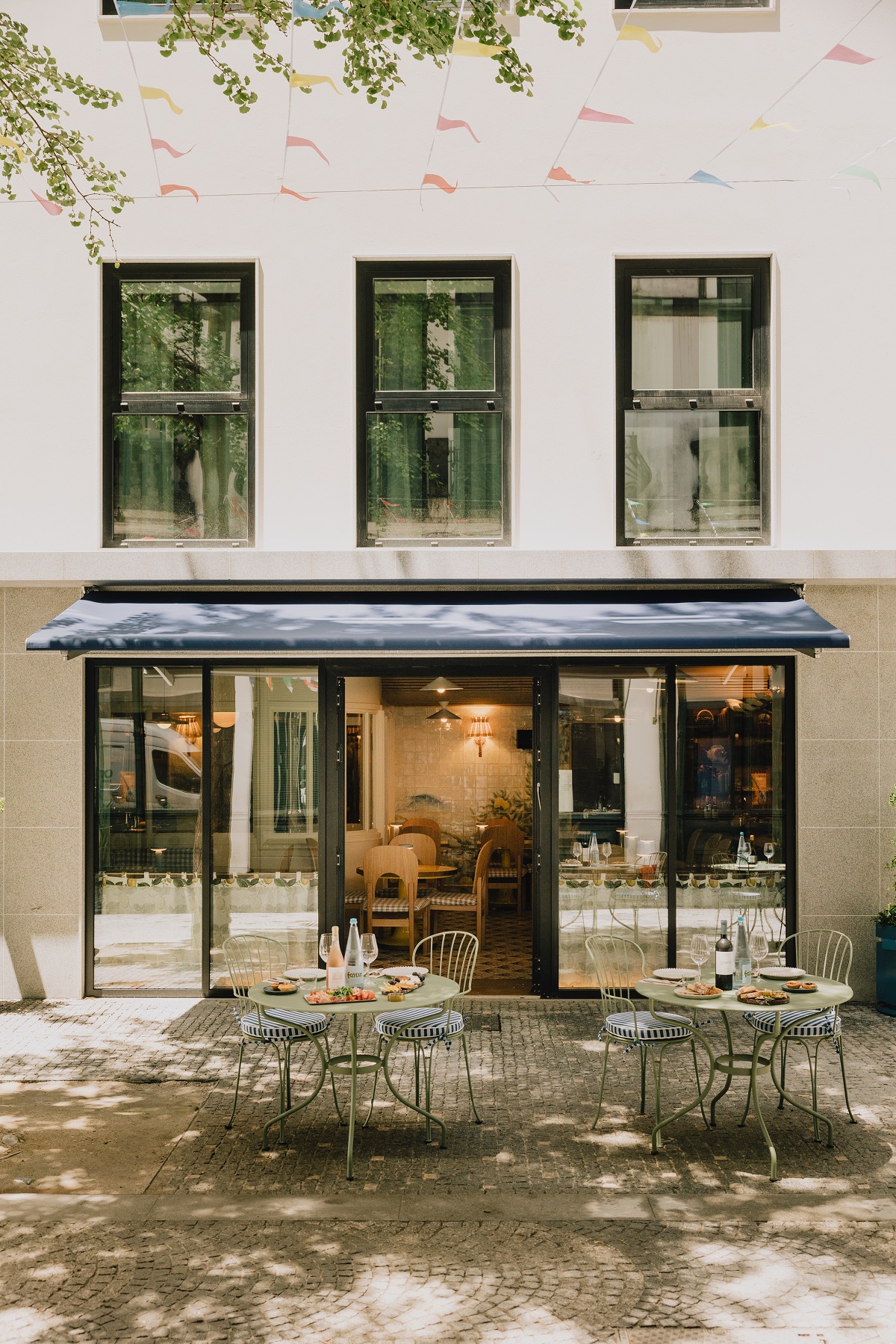 exterior facade and courtyrad with chairs and tables outside Wilde Porto