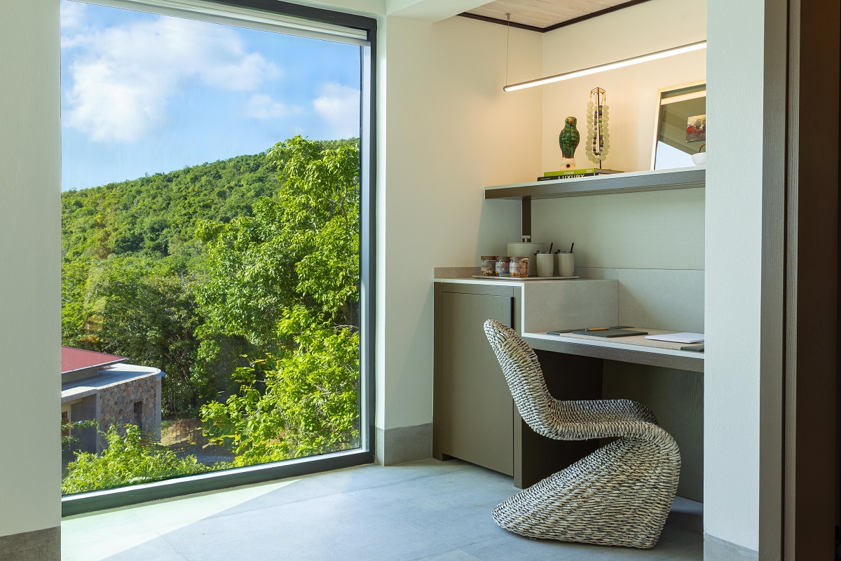 chair at desk in villa at The botany with floor to ceiling window with views of natural surroundings