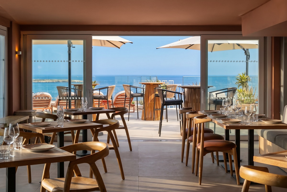 dining area opening on to terrace with sea view at INNSiDE Bugibba