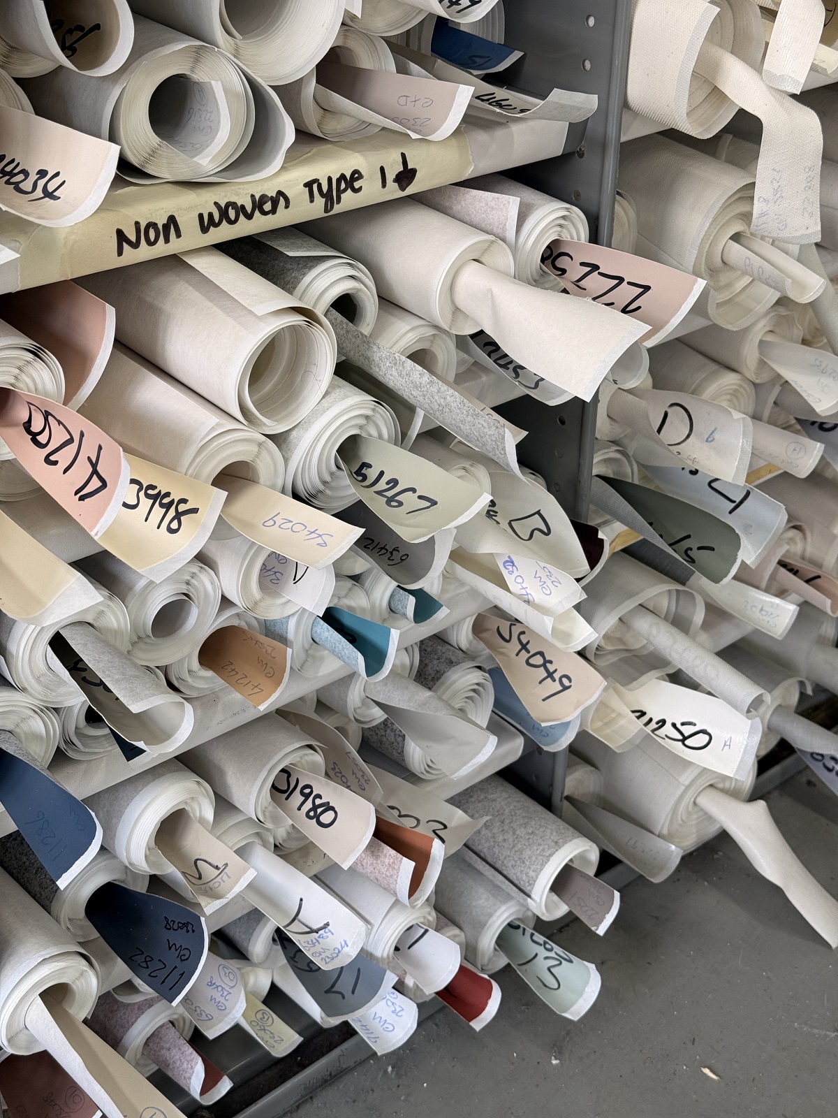 rolls of wallcovering designs in the muraspec workshop