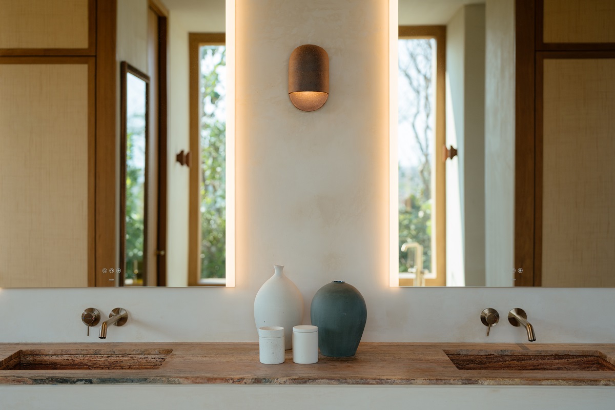 bathroom vanity detail with sea views reflected in the mirror