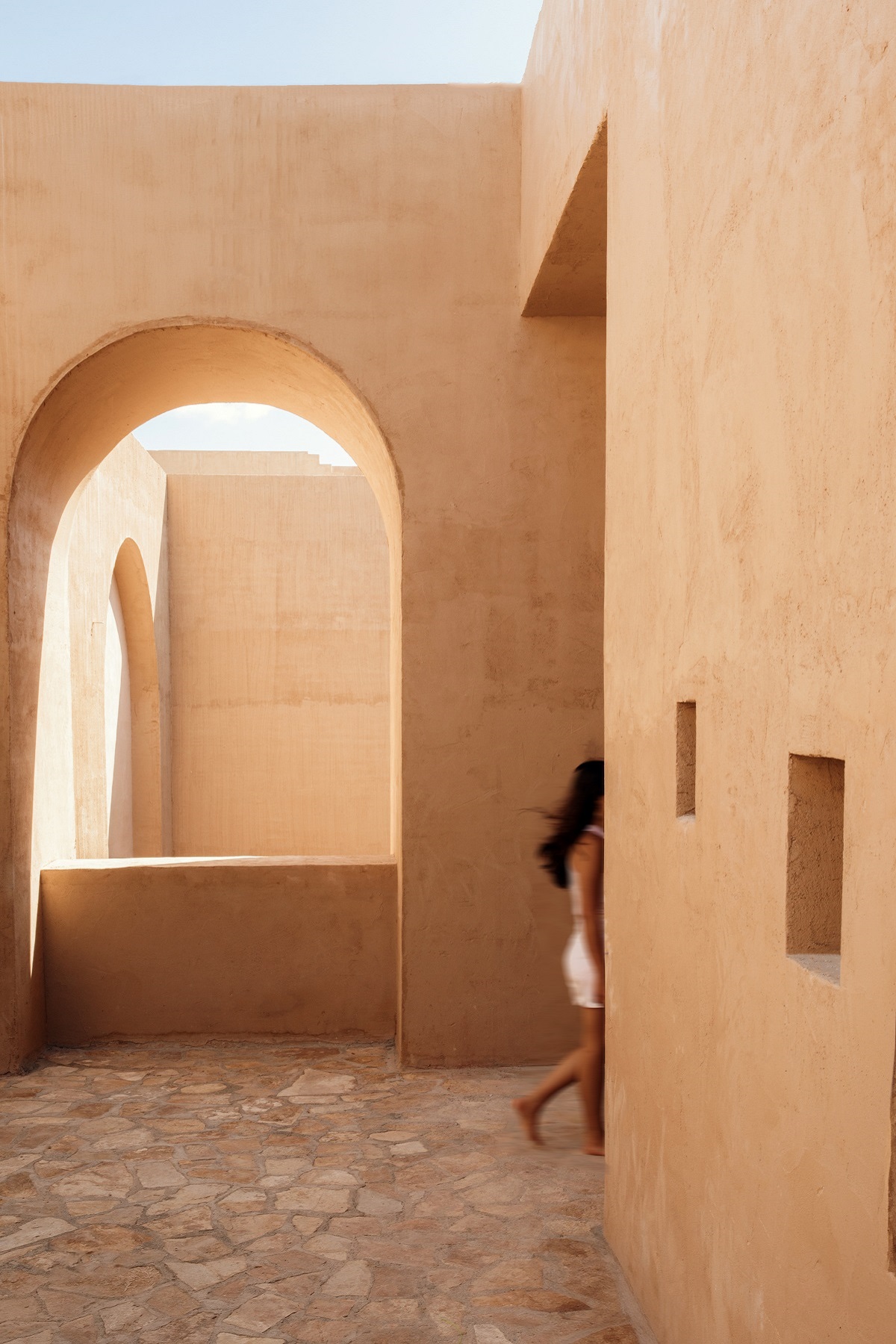 clay coloured walls and architectural passageway