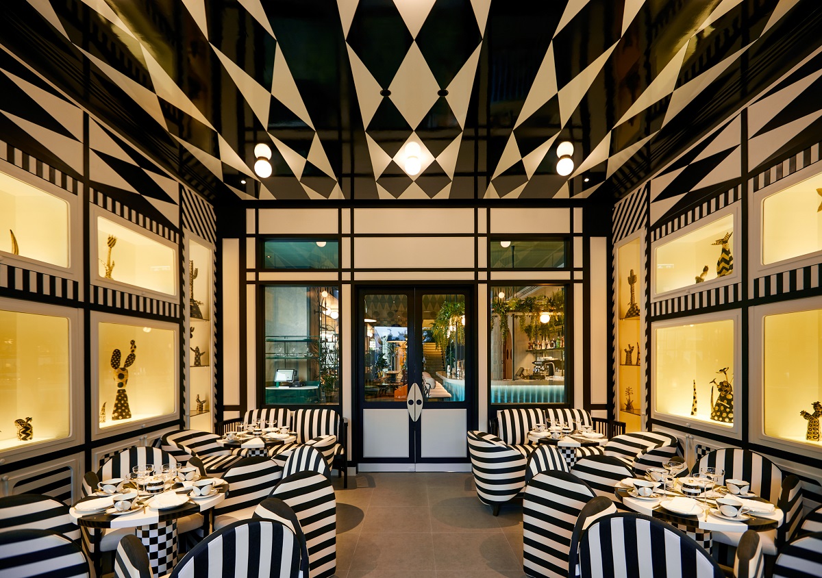 black and white ceiling above striped black and white furniture