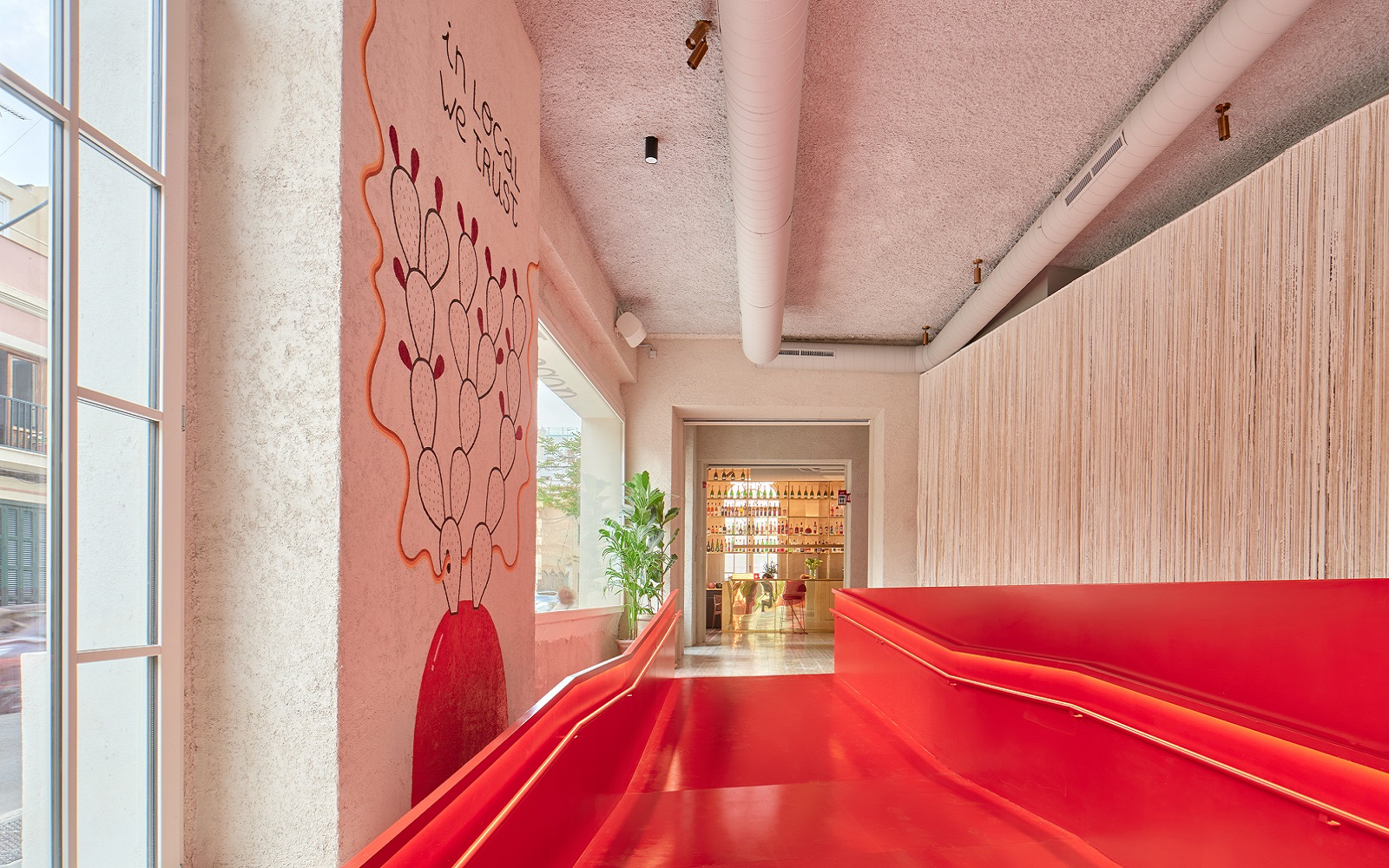 red entrance to hotel with graffitistyle artwork on the wall