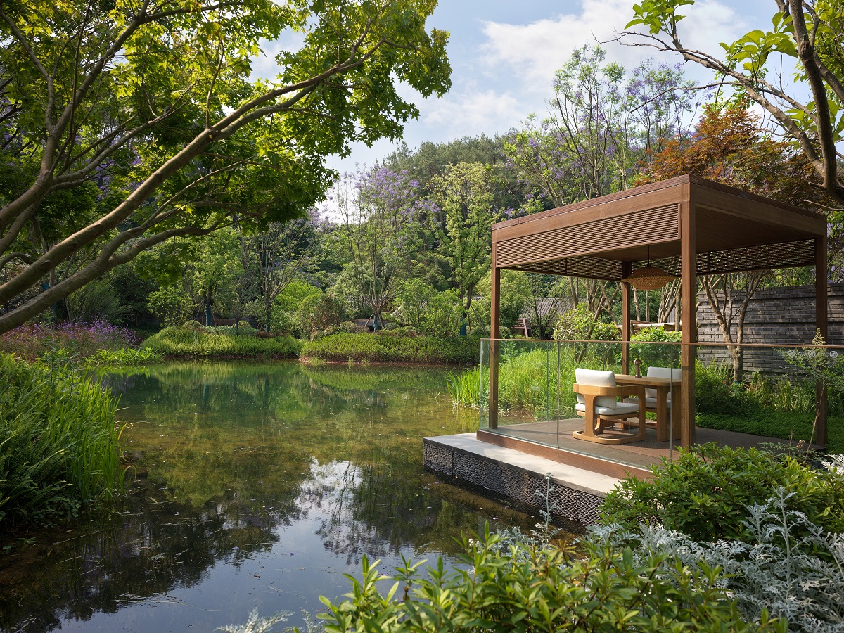 gazebo with chairs on lake at Banyan Tree Mount Emei One-Bedroom Lakeside Villa courtyard