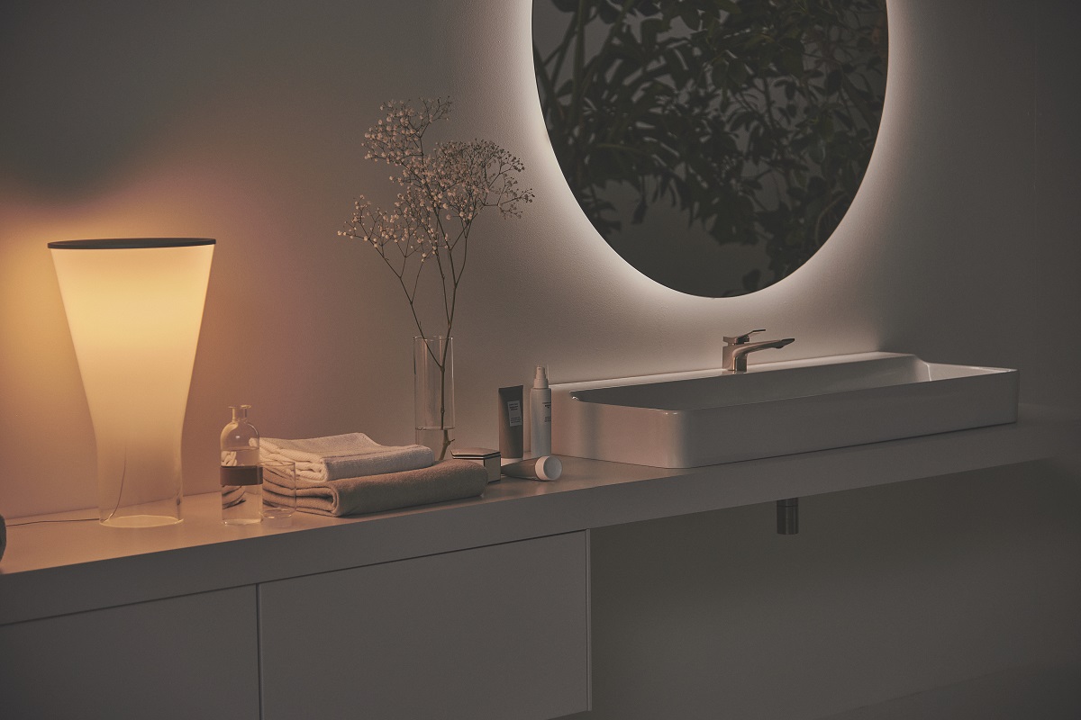 Conca mirror in low lighting above vanity