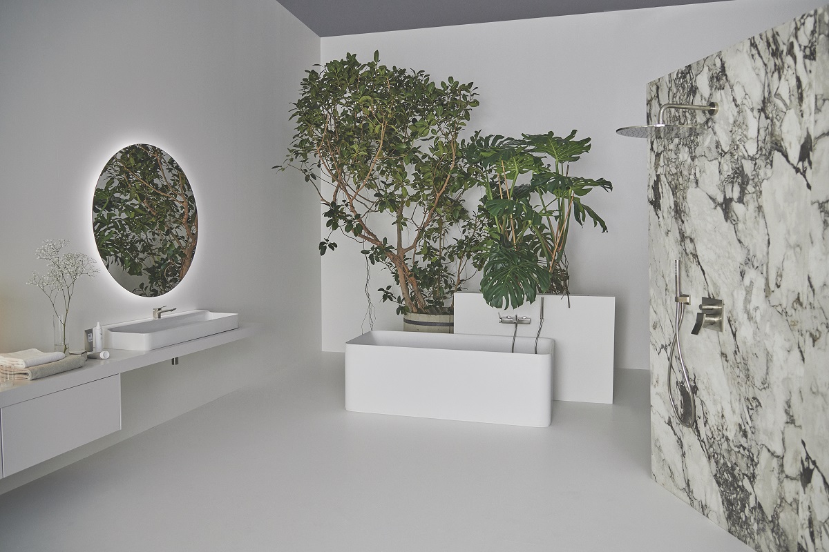 Conca Mirror from Ideal Standard in a white and grey marble bathroom with plants