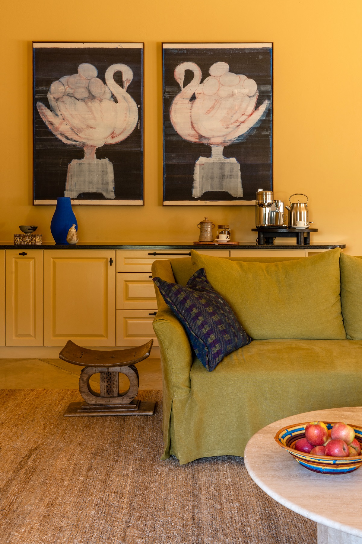 bold art against yellow walls