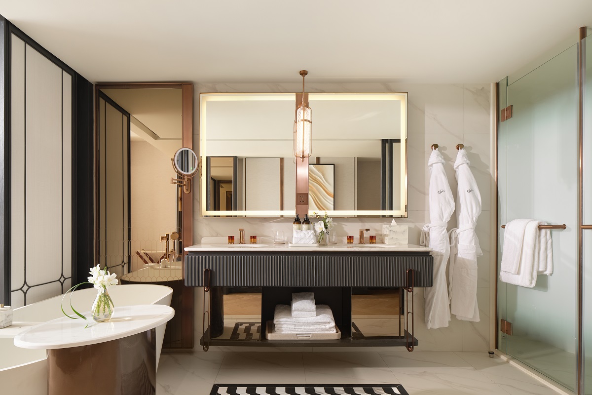 ensuite bathroom with double vanity, large mirror and bathrobes alongside