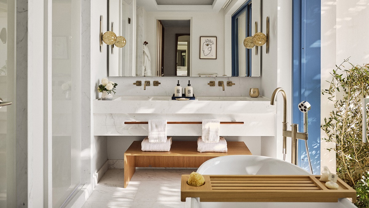 double vanity in white hotel bathroom with wood accents