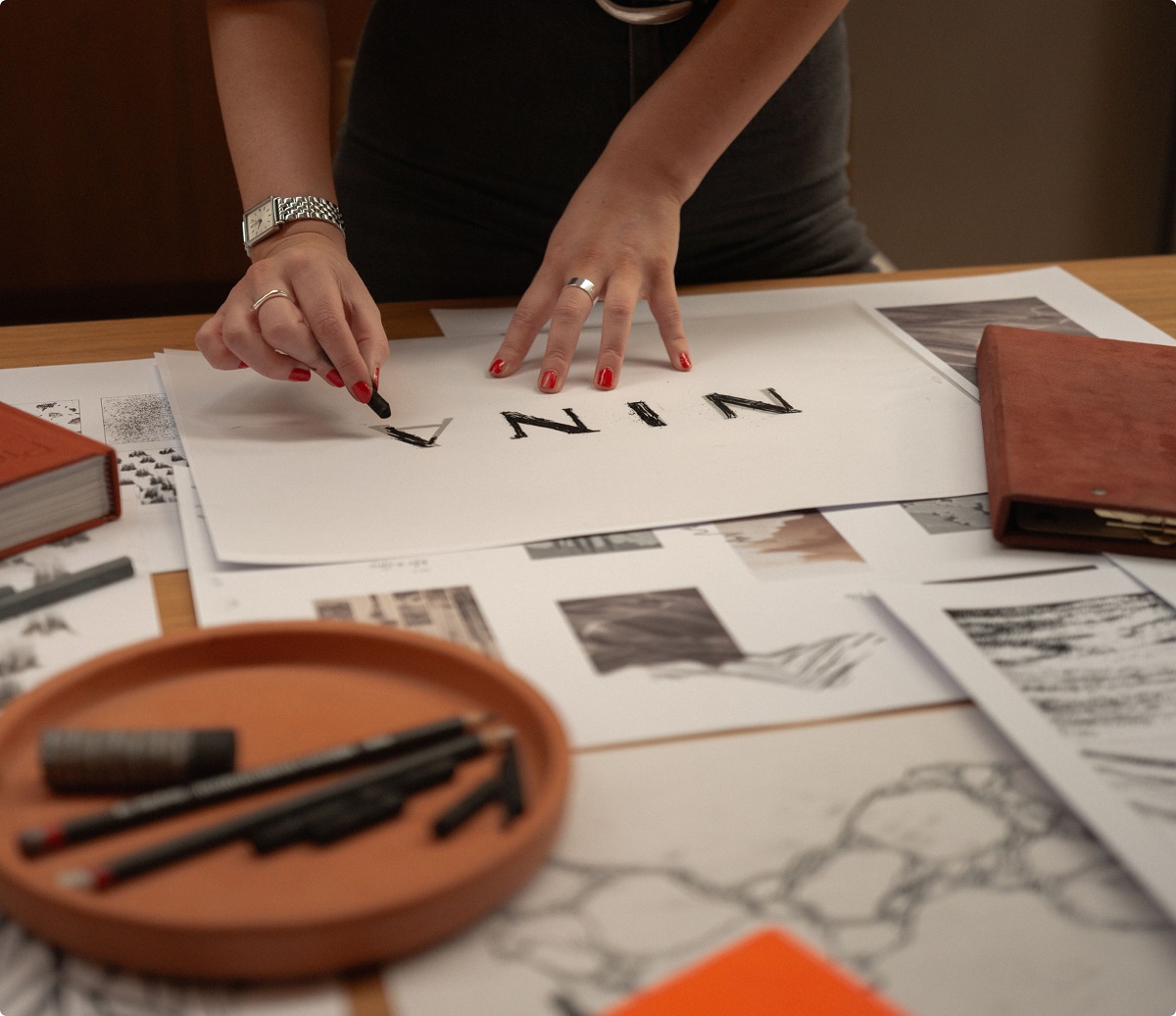 in the studio working on restuarant logo for Nina