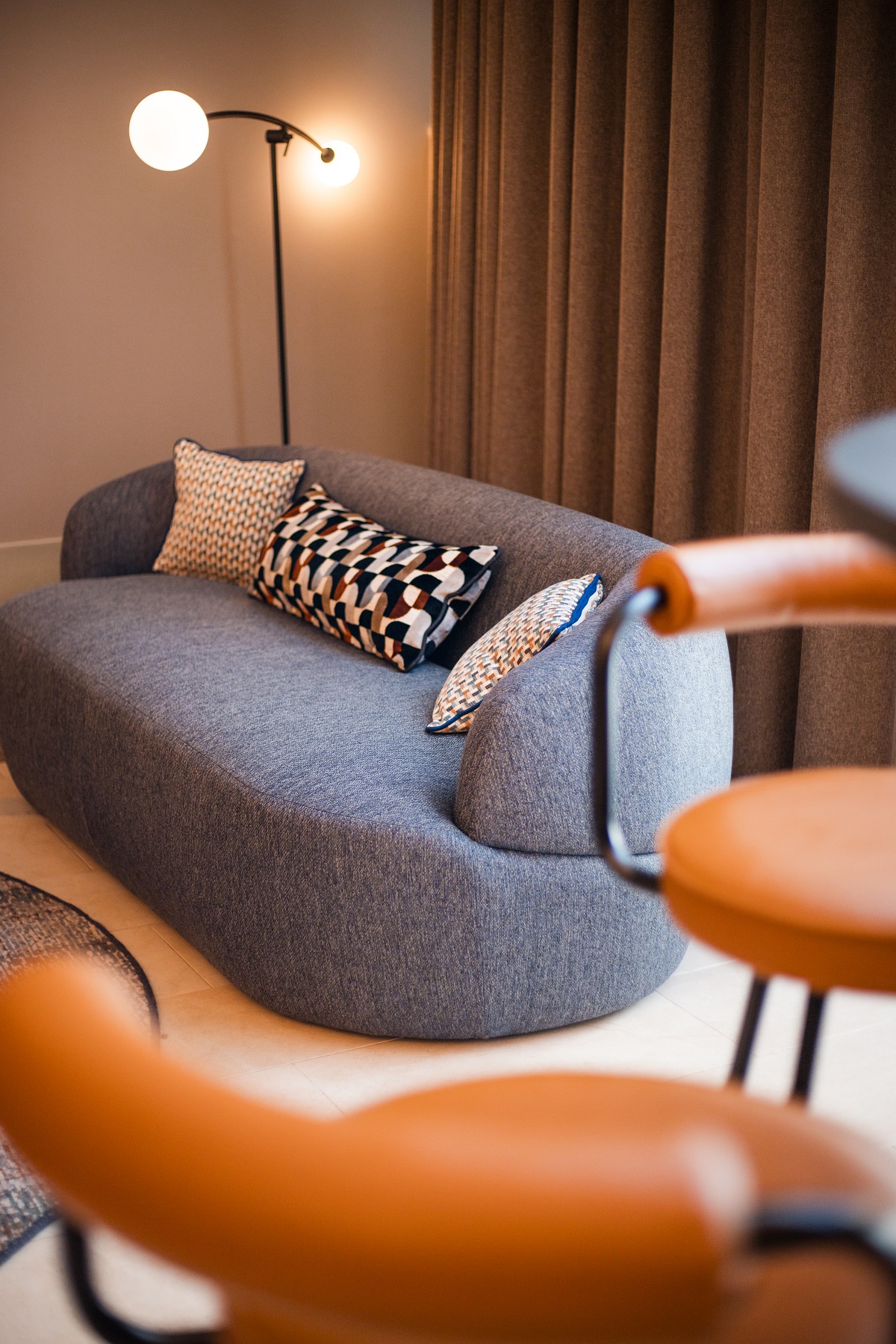 grey couch and brown leather chair detail with Northern Lights floor lamp