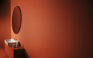 conca mirror from Ideal Standard on rust painted wall